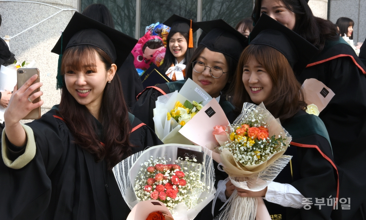 21일 충북대학교가 2018학년도 전기학위수여식을 개최한 가운데 졸업생들이 환한 표정으로 기념사진을 찍으며 대학생활의 마지막 추억을 담고 있다. / 김용수