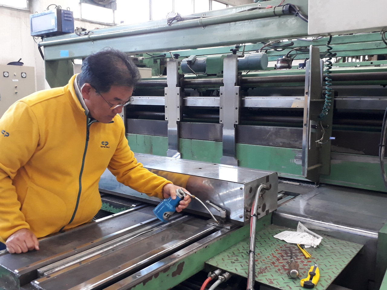 지에스피피 정용준 대표가 농산물박스 인쇄공장의 설비를 정비하고 있다.