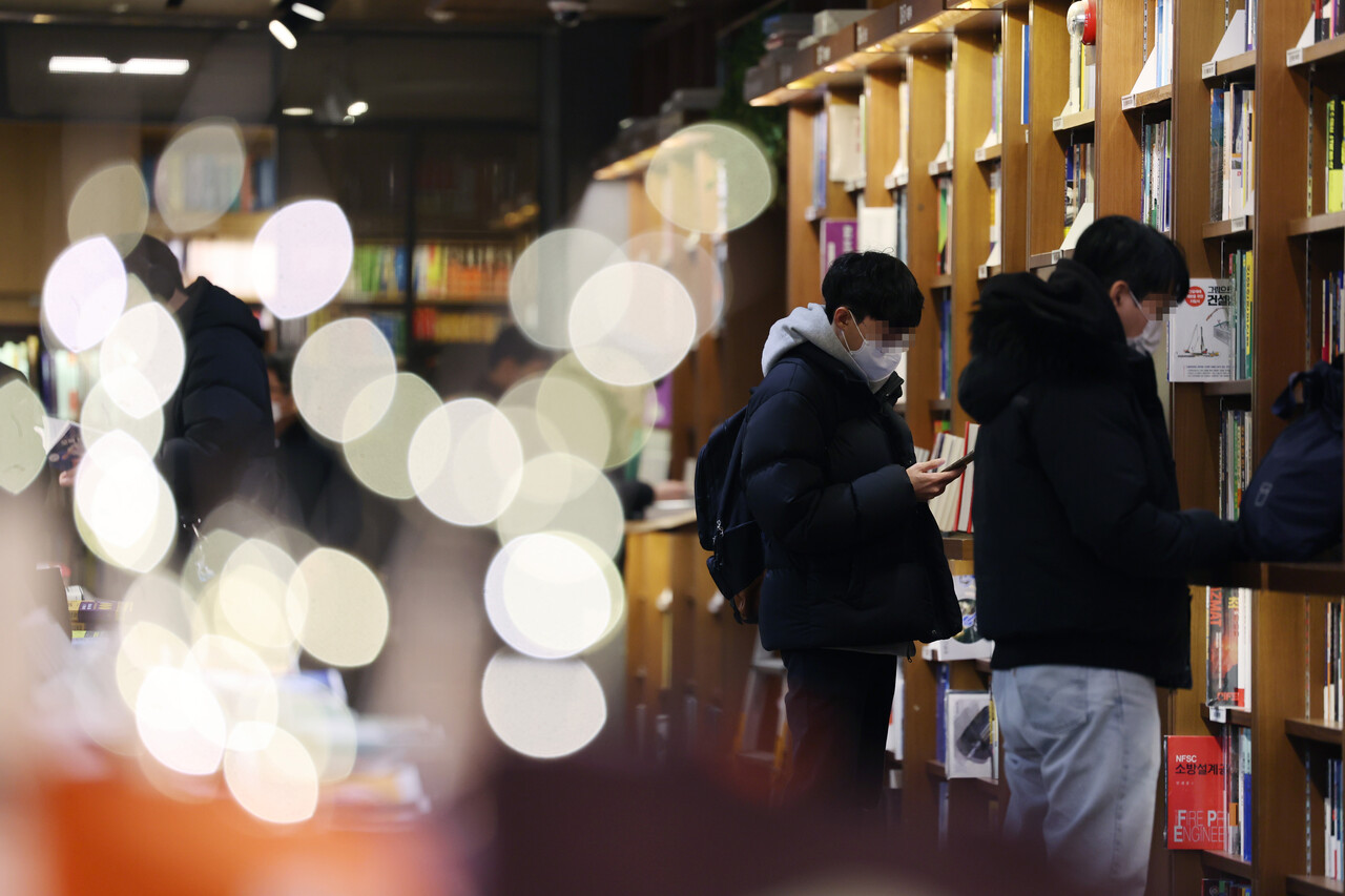 정부가 오는 30일부터 실내 마스크 착용을 '의무'에서 '권고'로 완화한 가운데 20일 오후 서울 시내의 한 대형서점에서 시민들이 마스크를 착용하고 있다. /연합뉴스